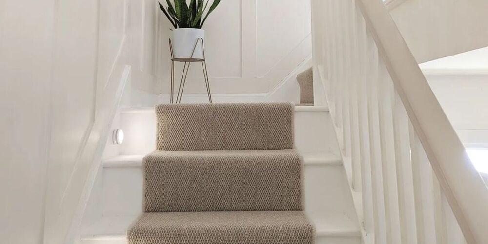 Striped carpet going up Victorian stairs